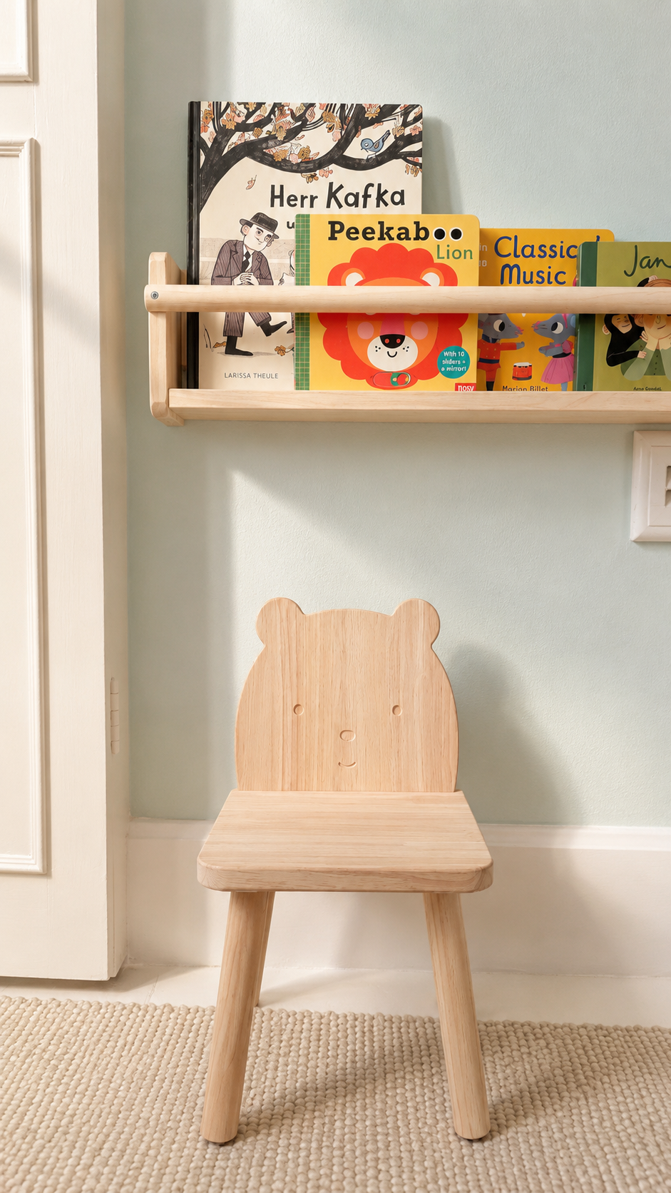 Timber child's chair beneath a book shelf in the London children's room