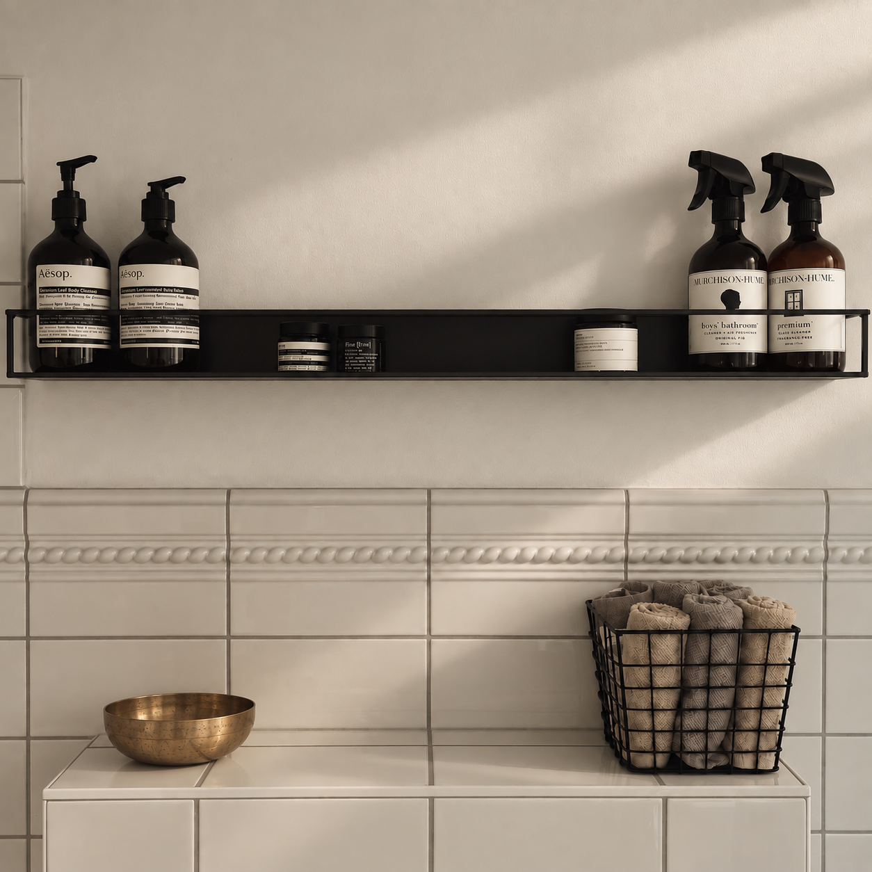 Bathroom shelf with neatly arranged bottles and rolled towels in the Brandenburg home